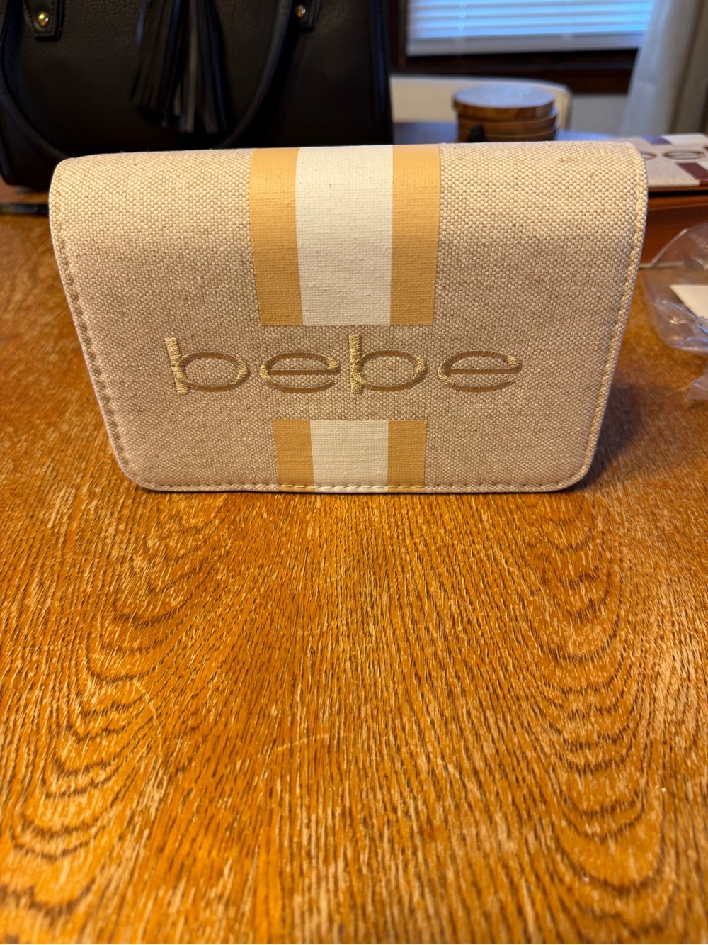 bebe Natural Canvas Clutch with Gold Embroidered Logo and Tan Stripe